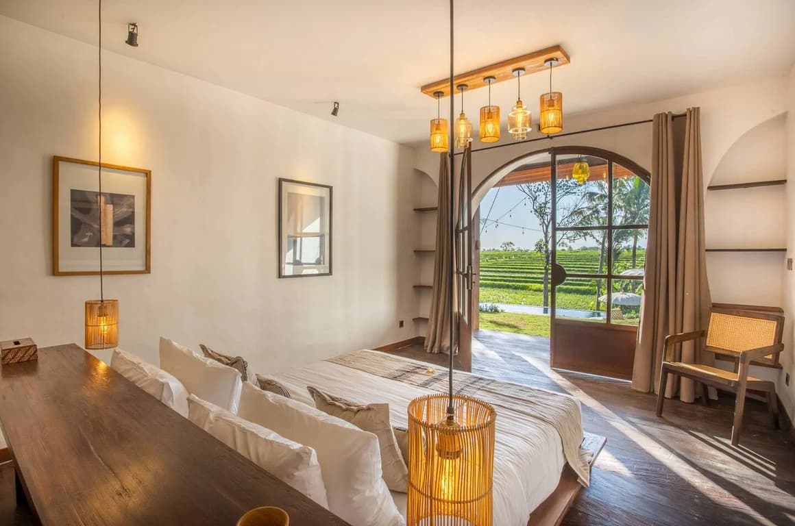 A large glass door from bedroom with swimming pool and ricefield view