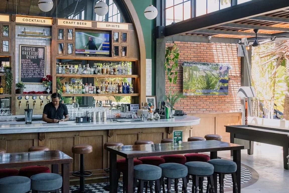 A bartender at The Barn Canggu preparing to open the bar