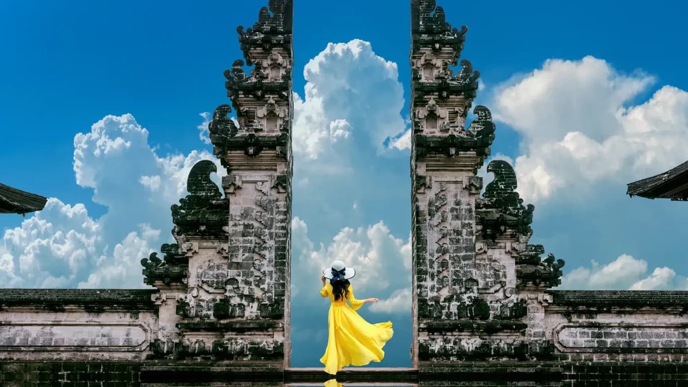 A female tourist take picture in front of the Pura Lempuyang